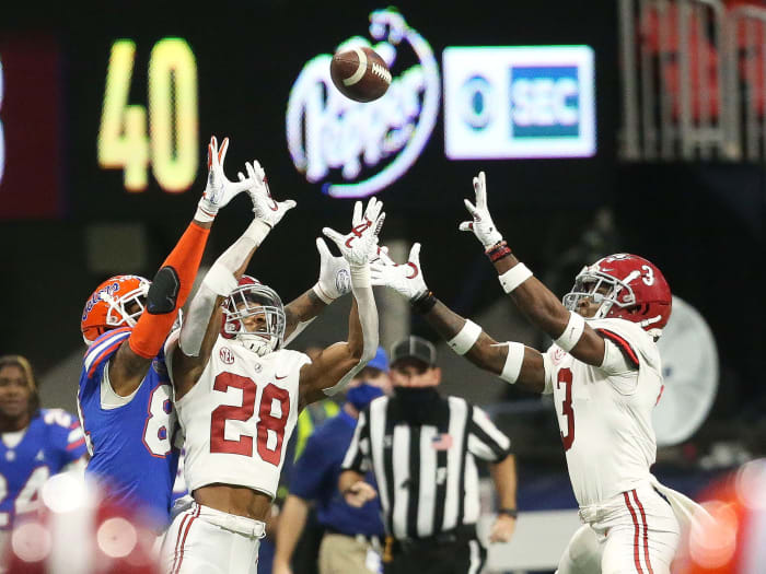 Alabama and Florida players both leap for a pass in the 2020 SEC title game